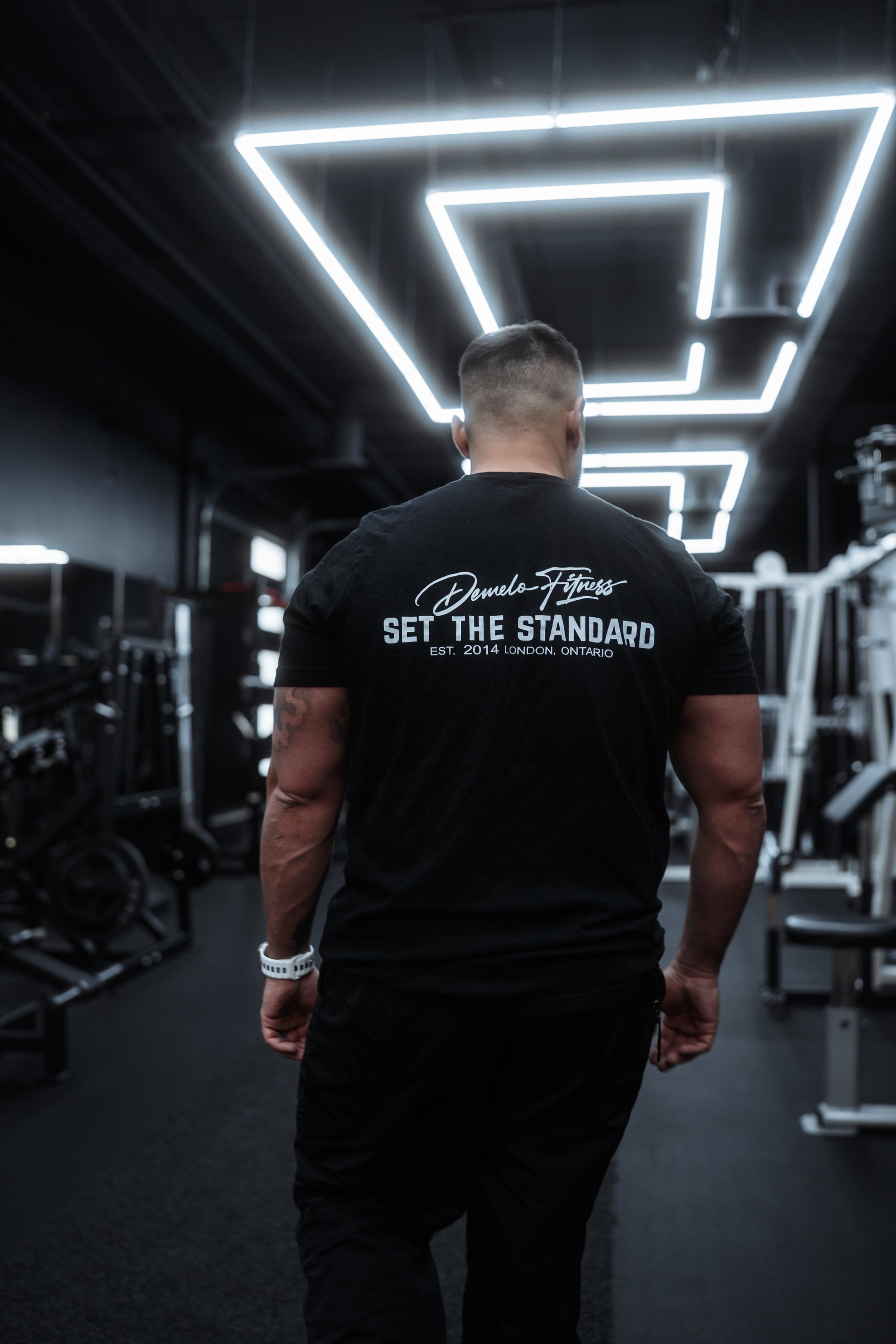 Josh DeMelo walking the floor in a Set the Standard tee